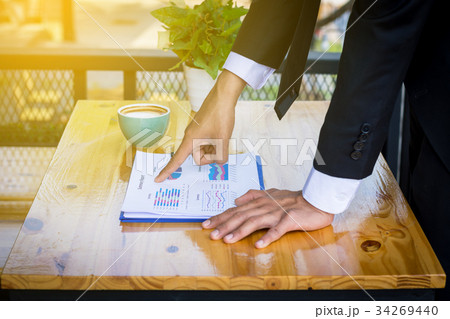 Finger business man pointing to the paper report 34269440