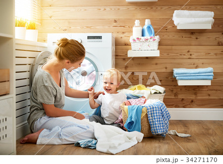 Happy family mother   housewife and children in   laundry load w 34271170