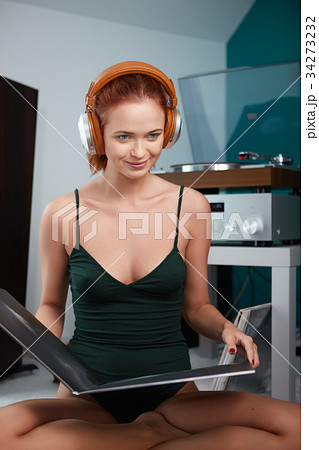 Woman listening vinyl at home. Evening atmosphere Woman listening vinyl at home. Evening atmosphere 34273232