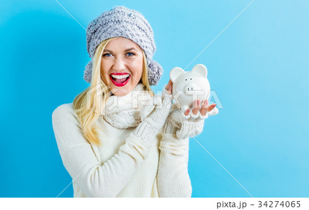 Young woman with a piggy bank Young woman with a piggy bank 34274065