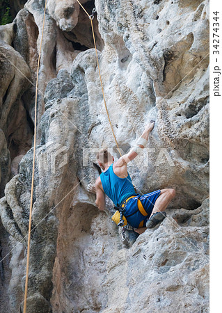 Young man rock climbing on white mountain 34274344