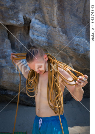 Young man rock climbing on white mountain 34274345