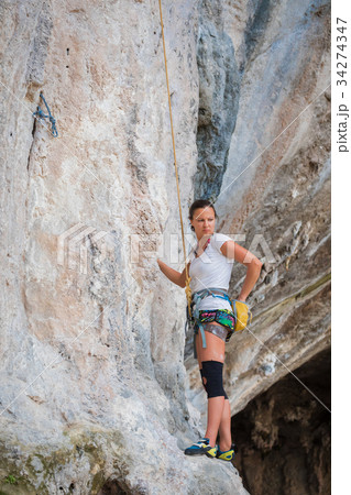 Young woman rock climbing on white mountain Young woman rock climbing on white mountain 34274347