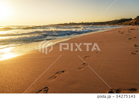 beach, wave and footprints at sunset time beach, wave and footprints at sunset time 34275143