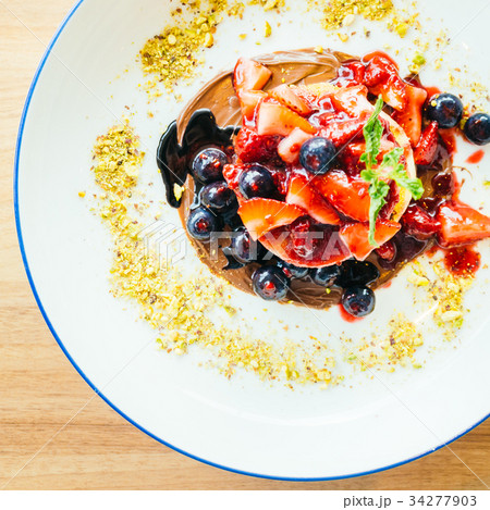 Pancakes with mixed berry fruit in white plate Pancakes with mixed berry fruit in white plate 34277903