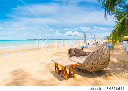 Chair and table dinning on the beach and sea with blue sky Chair and table dinning on the beach and sea with blue sky 34278631