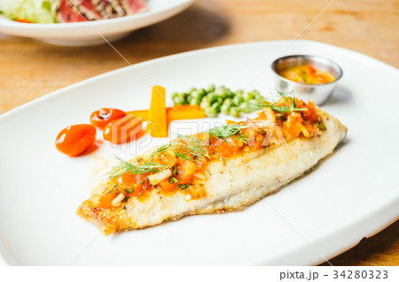 Grilled sea bass fish meat with sauce 34280323