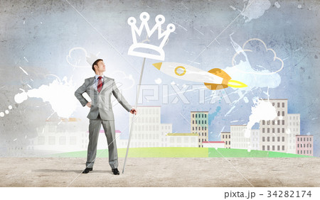 Young handsome businessman wearing white paper crown Young handsome businessman wearing white paper crown 34282174