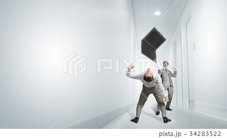 Two business people fighting with each other 34283522