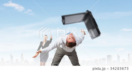 Two business people fighting with each other Two business people fighting with each other 34283673