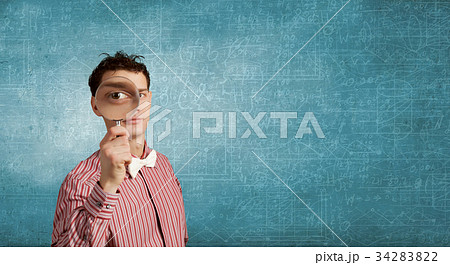 Guy looking in magnifying glass 34283822