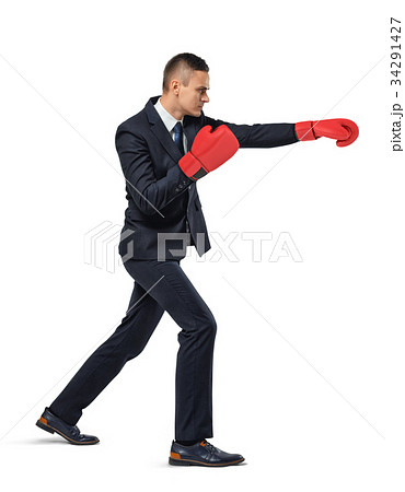 A businessman stands in side view on white A businessman stands in side view on white 34291427
