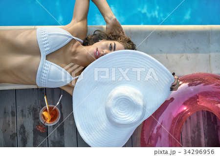 Model near swimming pool outdoors Model near swimming pool outdoors 34296956