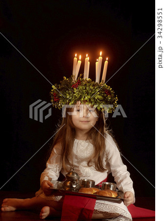 Little caucasian girl in Saint Lucia costume Little caucasian girl in Saint Lucia costume 34298551