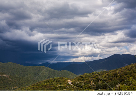 Green mountain covered with forest on the blue sky Green mountain covered with forest on the blue sky 34299194