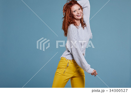 young redhead woman in autumn color isolated on fall background young redhead woman in autumn color isolated on fall background 34300527