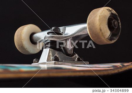 Close up of skateboard truck and wheels 34304899