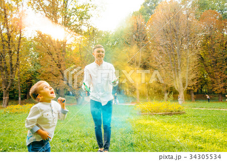 Fathers and children in the park palys with holi 34305534