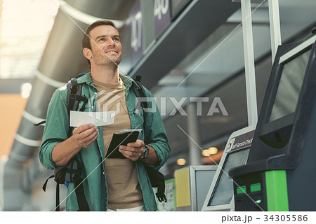 Delightful traveler is waiting for flight 34305586