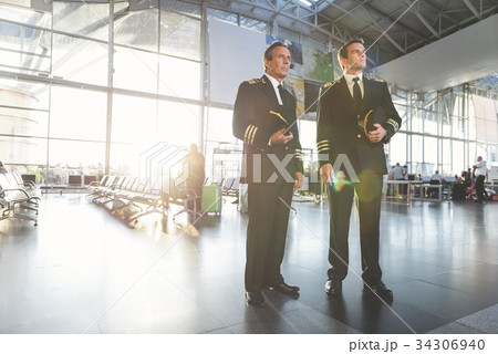 Serious aviators locating at airport 34306940