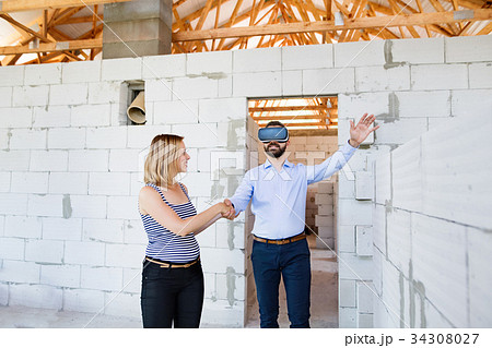 Young married couple at the construction site. Young married couple at the construction site. 34308027