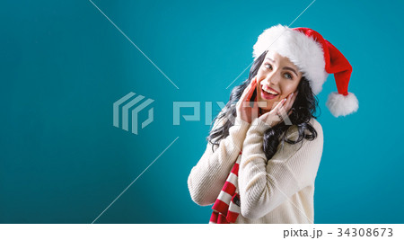 Happy young woman with Santa hat  34308673