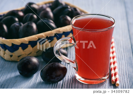 Homemade plum kissel on wooden table. Homemade plum kissel on wooden table. 34309782