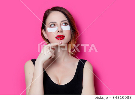 Woman using eye patch for her eyes 34310088
