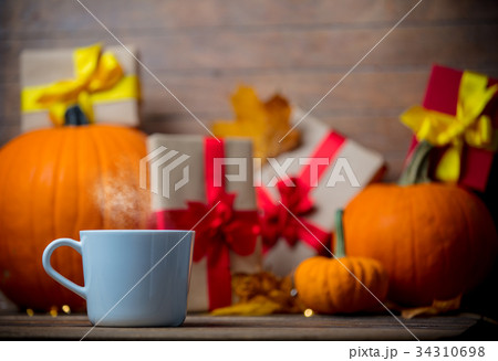 leaves and pumpkin with Halloween gift box and Tea 34310698