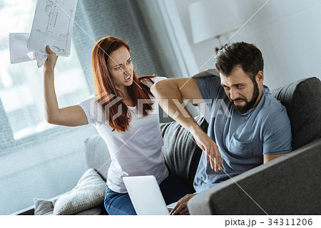 Furious red haired woman being angry at her 34311206