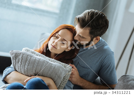 Sad unhappy couple sitting together Sad unhappy couple sitting together 34311221