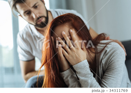 Unhappy cheerless woman being in despair Unhappy cheerless woman being in despair 34311769