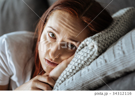Sad young woman feeling melancholic Sad young woman feeling melancholic 34312116