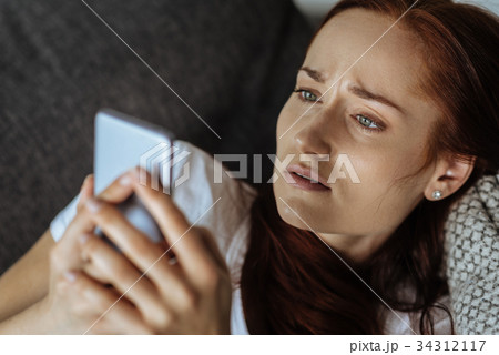 Moody depressed woman using social networks 34312117