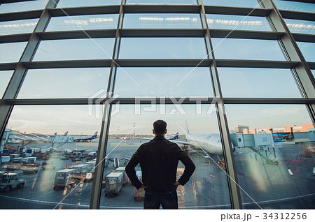 Silhouette of man waiting for the flight 34312256