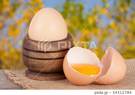 egg in a wooden bowl on a board with blurred egg in a wooden bowl on a board with blurred 34312784