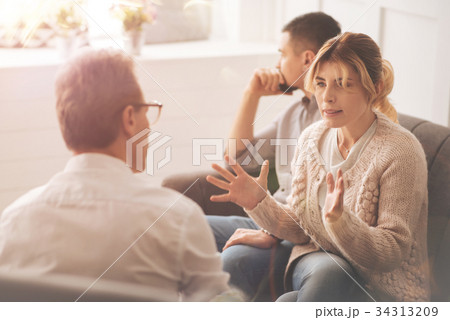 Unhappy moody woman complaining to the therapist Unhappy moody woman complaining to the therapist 34313209