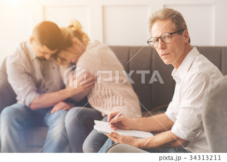 Intelligent male psychologist looking at you Intelligent male psychologist looking at you 34313211