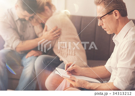 Professional male psychologist taking notes 34313212