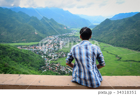 Asian man looking at mountain Asian man looking at mountain 34318351