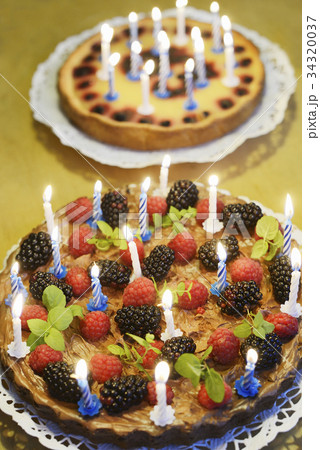two birthday cakes with candles 34320037