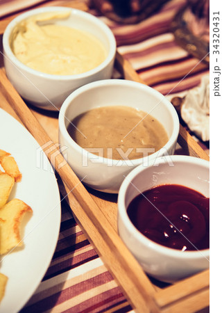 French fries with sauces on home table French fries with sauces on home table 34320431