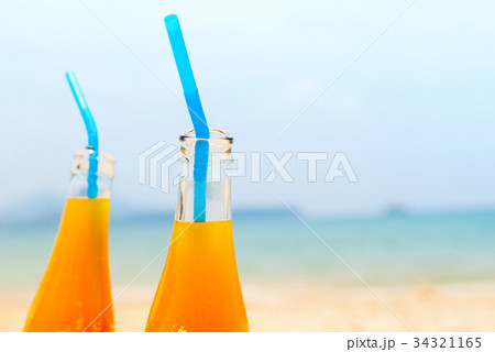 Two Orange Juice Bottles Sea Background Summer Two Orange Juice Bottles Sea Background Summer 34321165