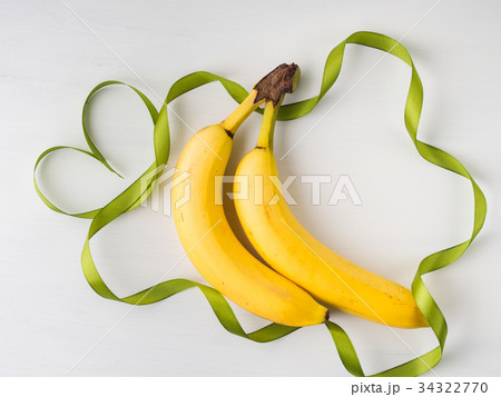Two bananas with green ribbon frame Two bananas with green ribbon frame 34322770