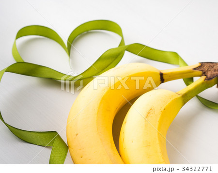 Two bananas with green ribbon frame Two bananas with green ribbon frame 34322771