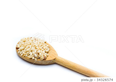 Yellow rice seeds in a wooden spoon 34326574