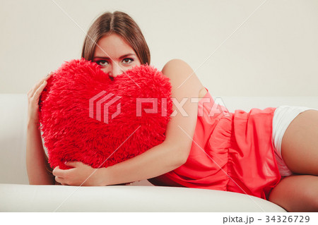 Woman hugging heart shape pillow. Valentines day. 34326729