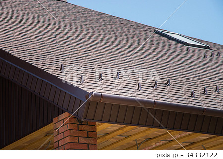 Tiled brown roof of new house with overflow 34332122