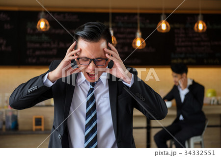 Asian angry and stress businessman screaming 34332551