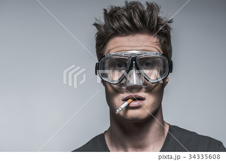 Confident heavy smoker in protective mask 34335608